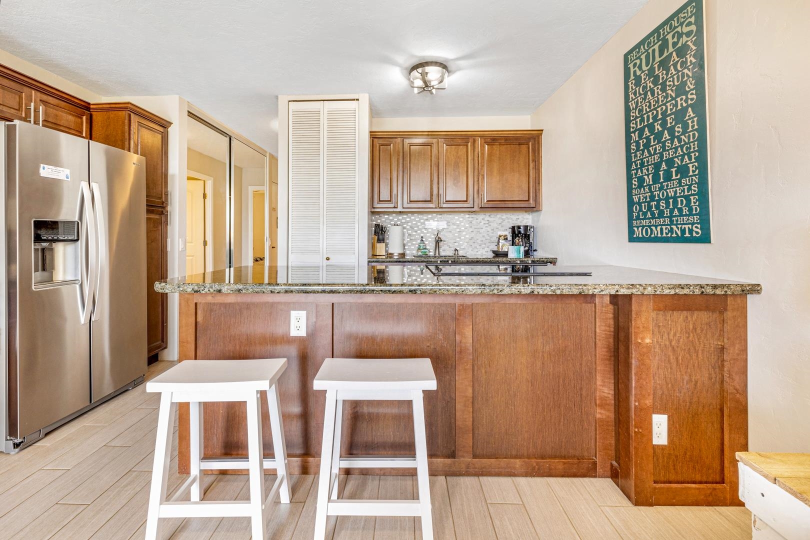 2191 South Kihei Road, Unit 1305 Kihei, HI 96753 - Photo 9 of 21 a kitchen with stainless steel appliances a sink and a refrigerator