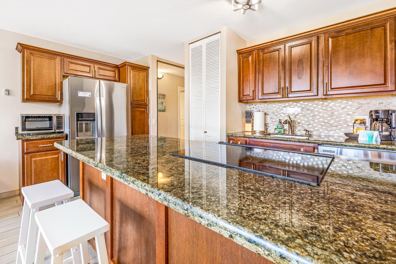 2191 South Kihei Road, Unit 1305 Kihei, HI 96753 - Photo 10 of 21 a view of a large kitchen with furniture and staircase