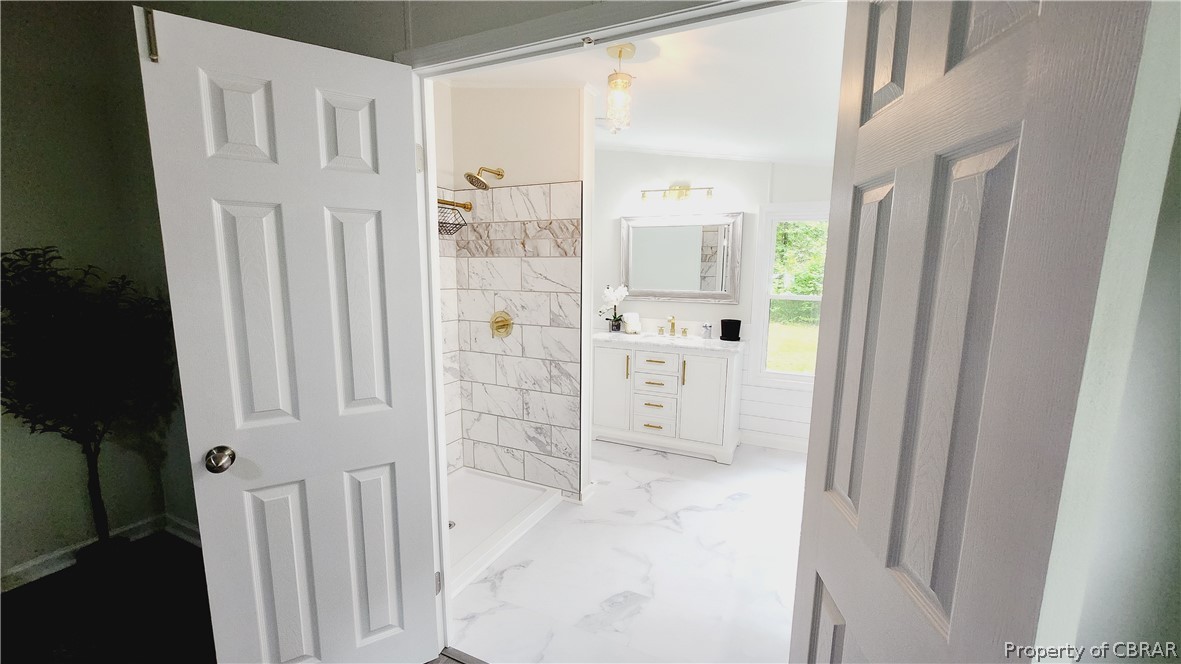 8065 Filly Run Road Gloucester, VA 23061 - Photo 14 of 33 Bathroom with a tile shower, tile flooring, lofted ceiling, and vanity