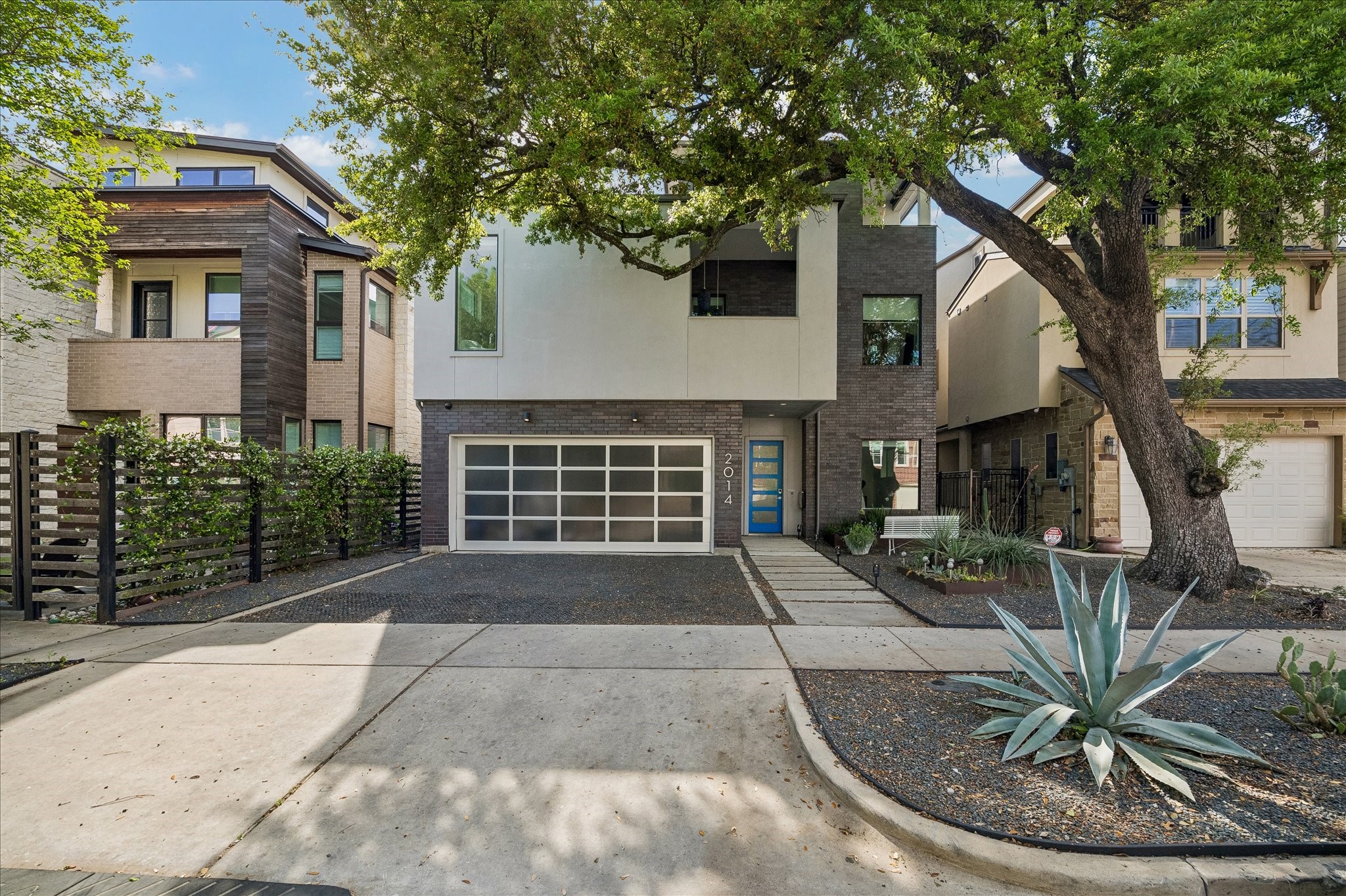 2014 Park Street Houston, TX 77019 - Photo 2 of 40 This contemporary home boasts gorgeous curb appeal with a striking stucco and brick elevation, a double-wide driveway, lush plantings, and a magnificent oak tree that defines the area.