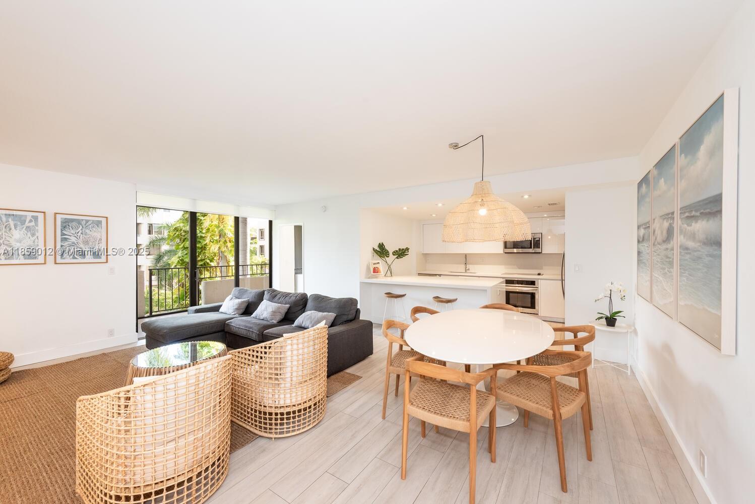 a dining room with furniture a chandelier and wooden floor