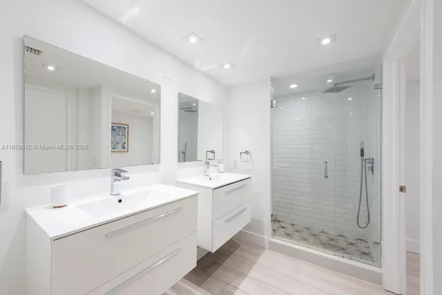 a bathroom with a shower sink and mirror