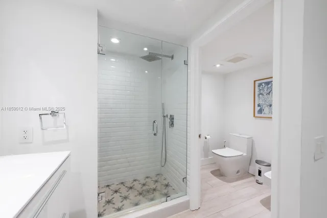 a bathroom with a sink toilet and shower