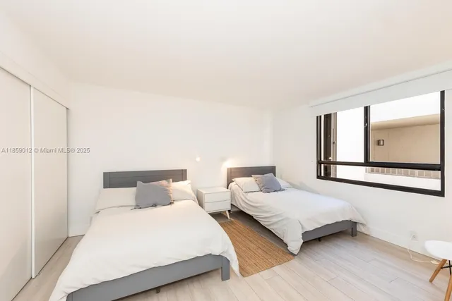 a bedroom with double bed and a large window