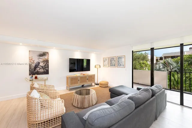 a living room with furniture a flat screen tv and a large window