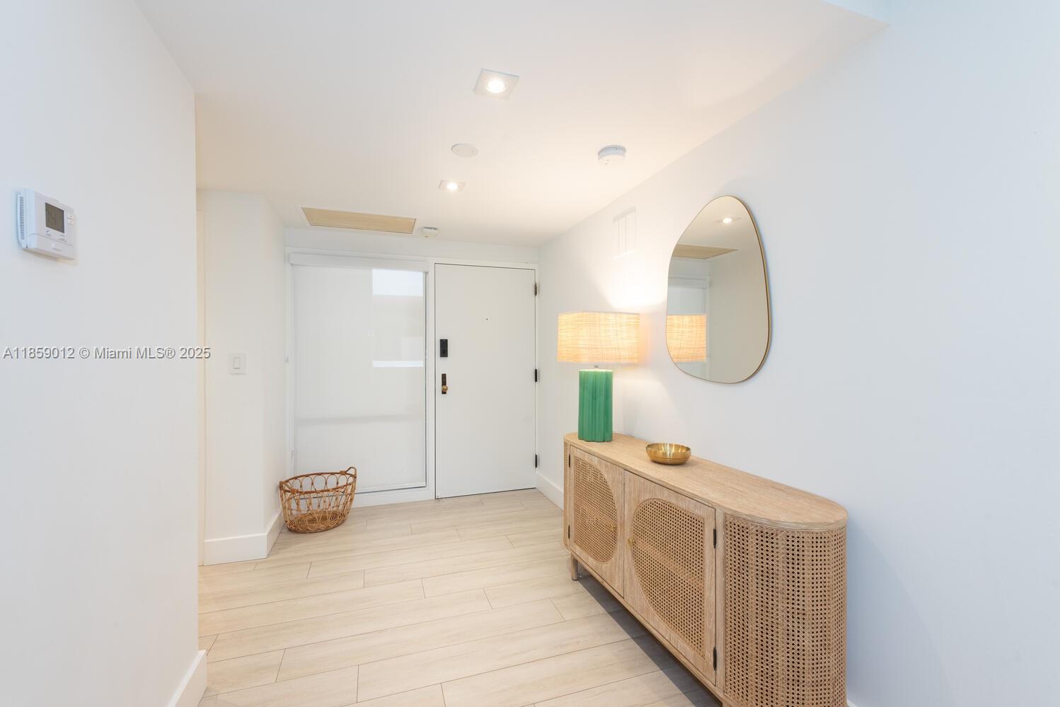 181 Crandon Boulevard, Unit 306 Key Biscayne, FL 33149 - Photo 25 of 25 a spacious bathroom with a double vanity sink and a mirror