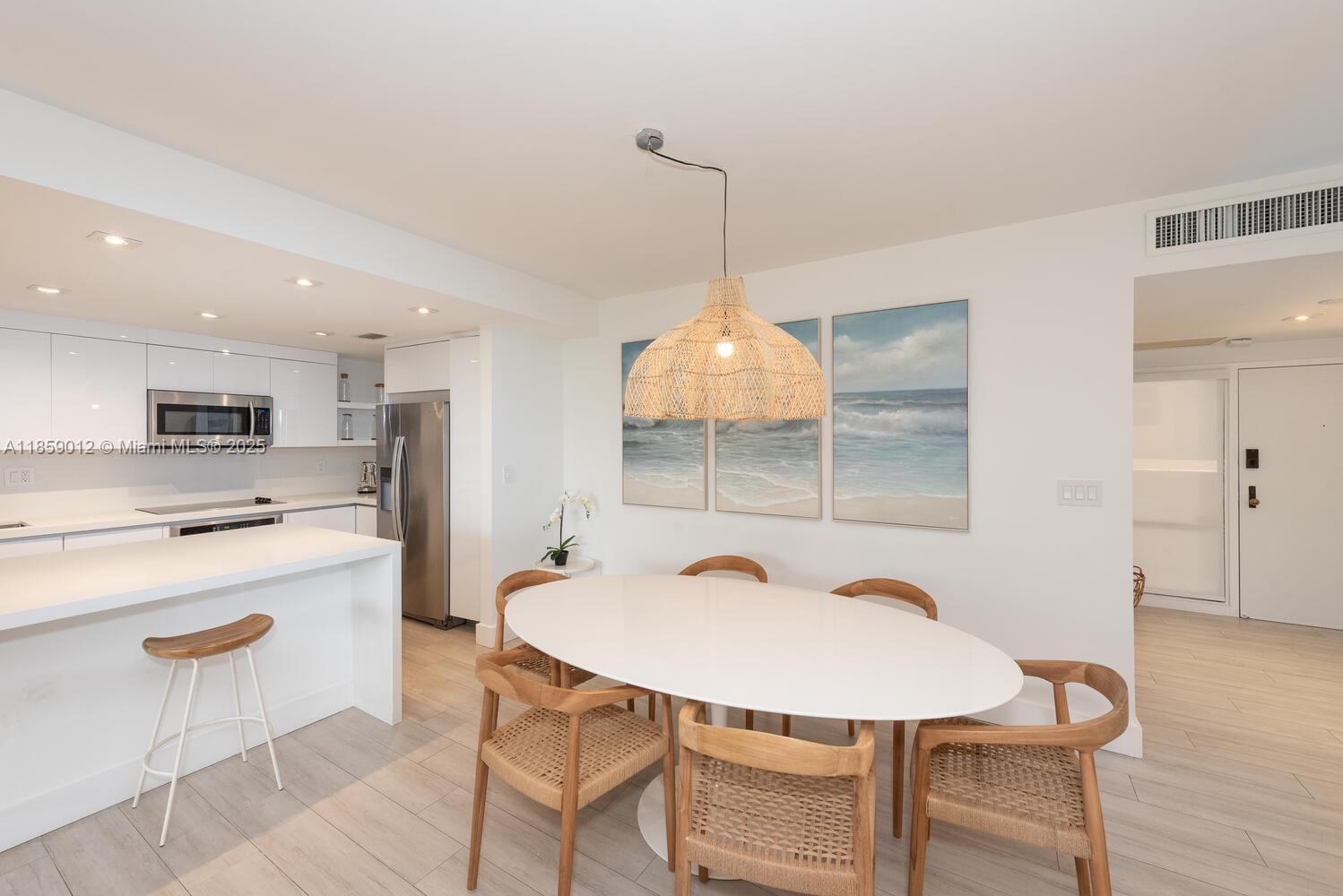 181 Crandon Boulevard, Unit 306 Key Biscayne, FL 33149 - Photo 5 of 25 a kitchen with stainless steel appliances kitchen island a table and chairs in it