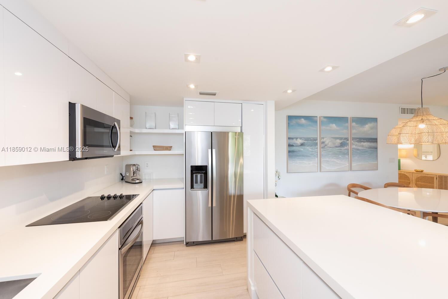 181 Crandon Boulevard, Unit 306 Key Biscayne, FL 33149 - Photo 8 of 25 a kitchen with a sink a stove and refrigerator