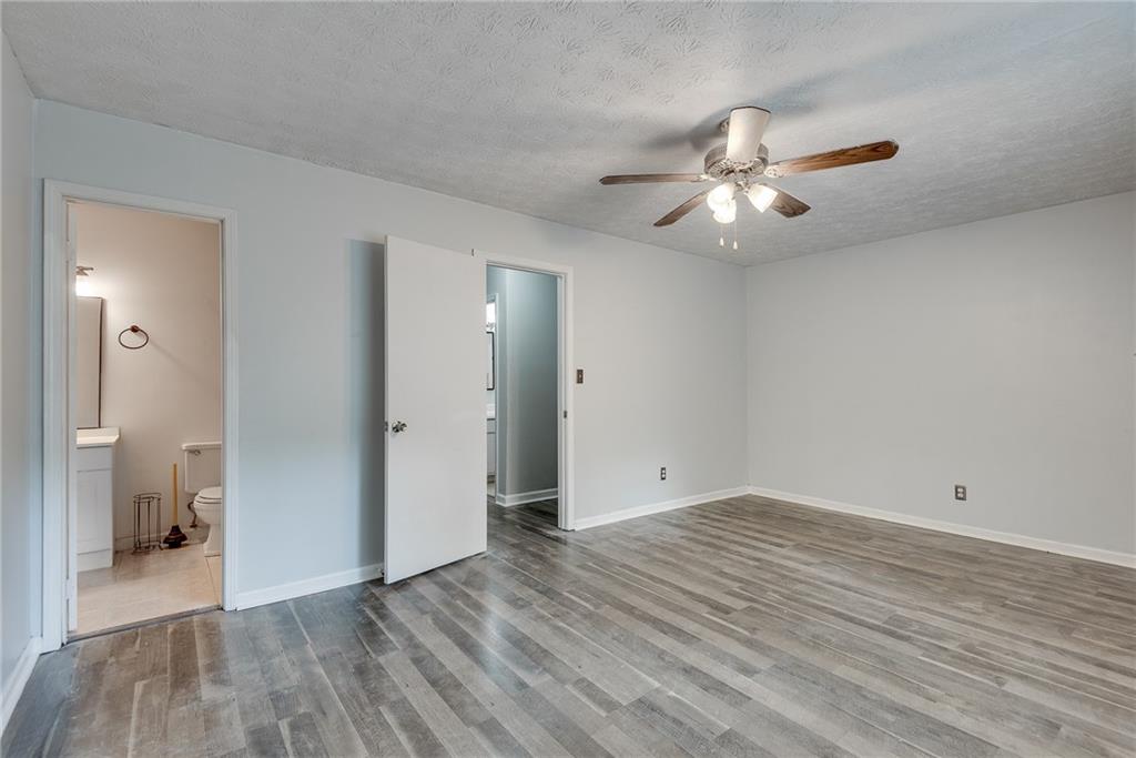 5611 Whittondale Road Lithonia, GA 30058 - Photo 19 of 34 wooden floor in an empty room with a bathroom