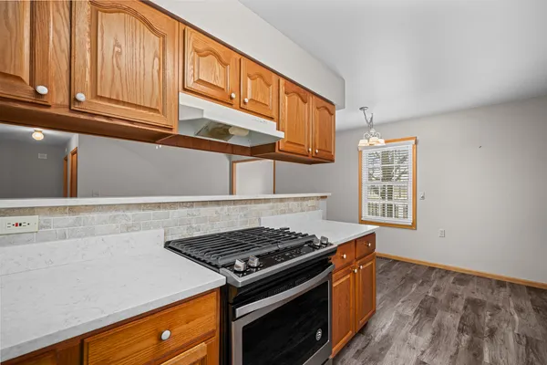 a stove top oven sitting inside of a kitchen