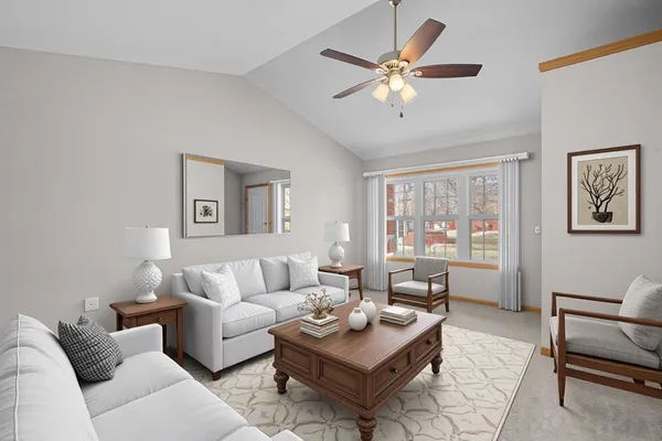 a living room with furniture a chandelier and a window