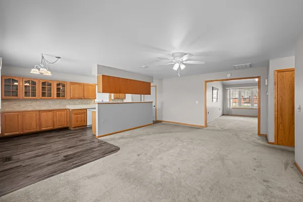 an empty room with windows and cabinet