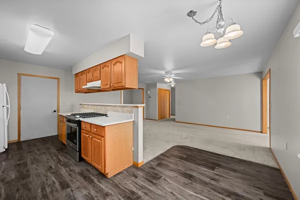 a kitchen with wooden floor and steel stainless steel appliances