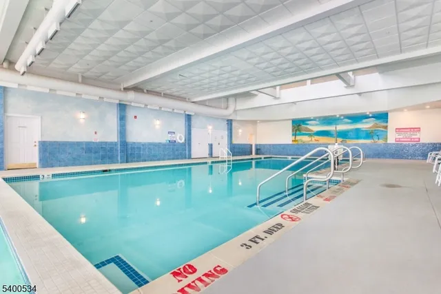 a living room with lots of furniture and a large window