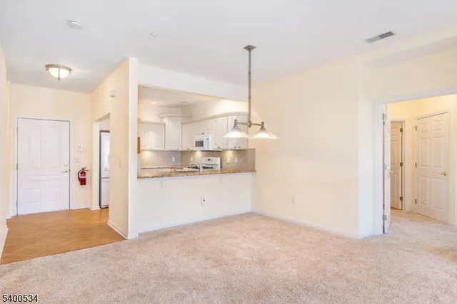a view of a kitchen with a sink and cabinets