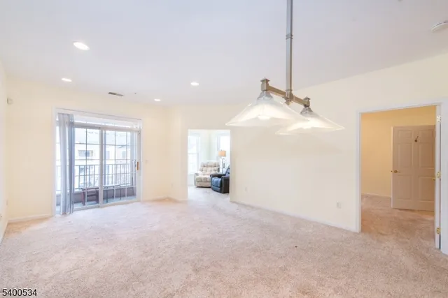 a view of a livingroom with wooden floor and a ceiling fan