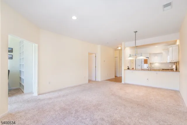 a view of a kitchen with a refrigerator and a sink