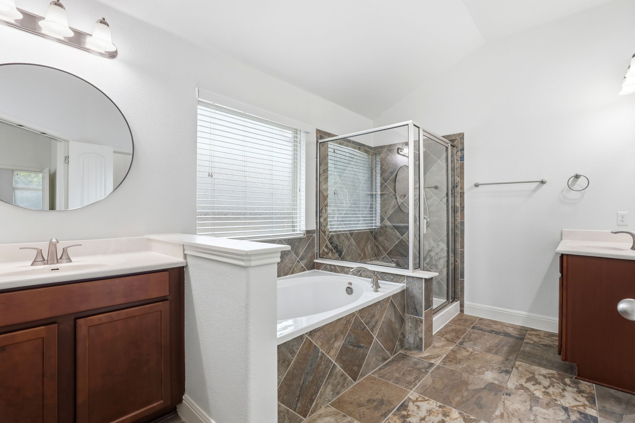 152 Stone View Trail Austin, TX 78737 - Photo 21 of 33 Full bath with vanity, a bath, a shower stall, stone tile flooring, and vaulted ceiling