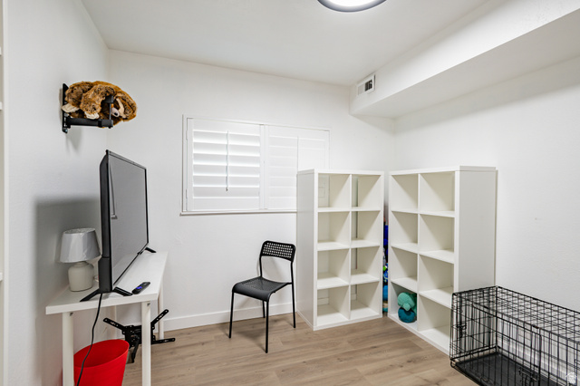 1221 Waterside Cove, Unit 11 Midvale, UT 84047 - Photo 13 of 23 Versatile room with wood-finish flooring, white walls, and a window featuring plantation shutters