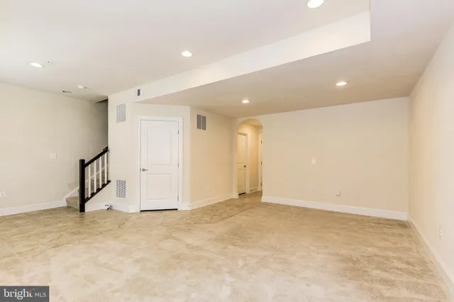 an empty room with a empty space and windows