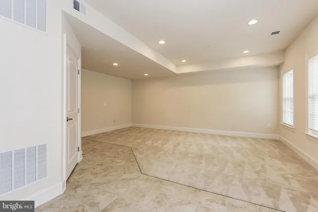a bathroom with a granite countertop sink a toilet and shower