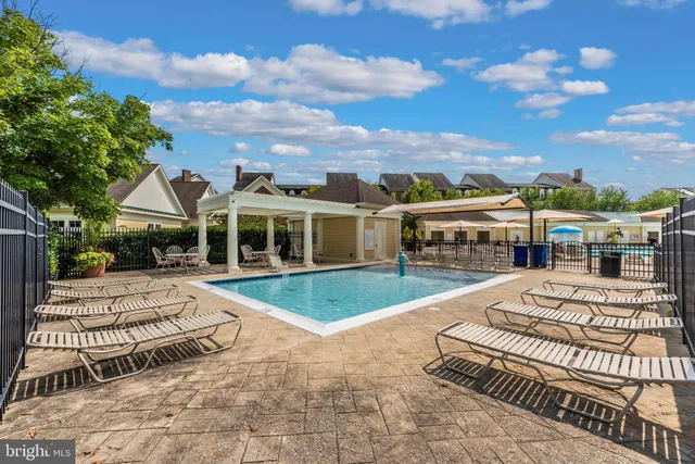 a swimming pool view with a outdoor seating