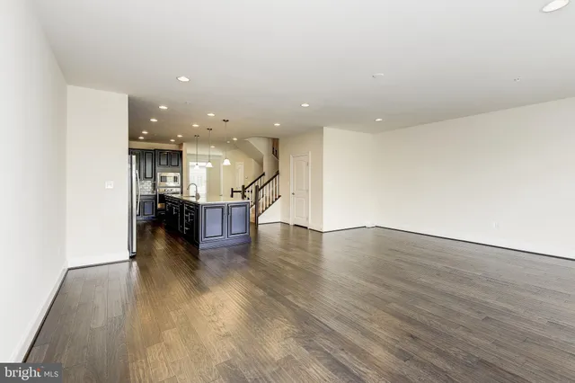 a view of kitchen and hall with wooden floor