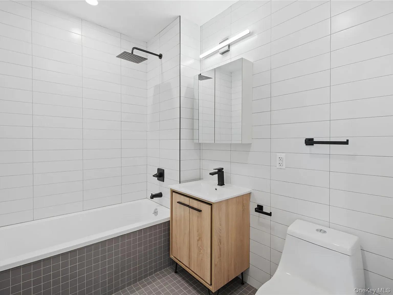 55-40 97th Place Queens, NY 11368 - Photo 2 of 2 a bathroom with a sink a toilet and shower