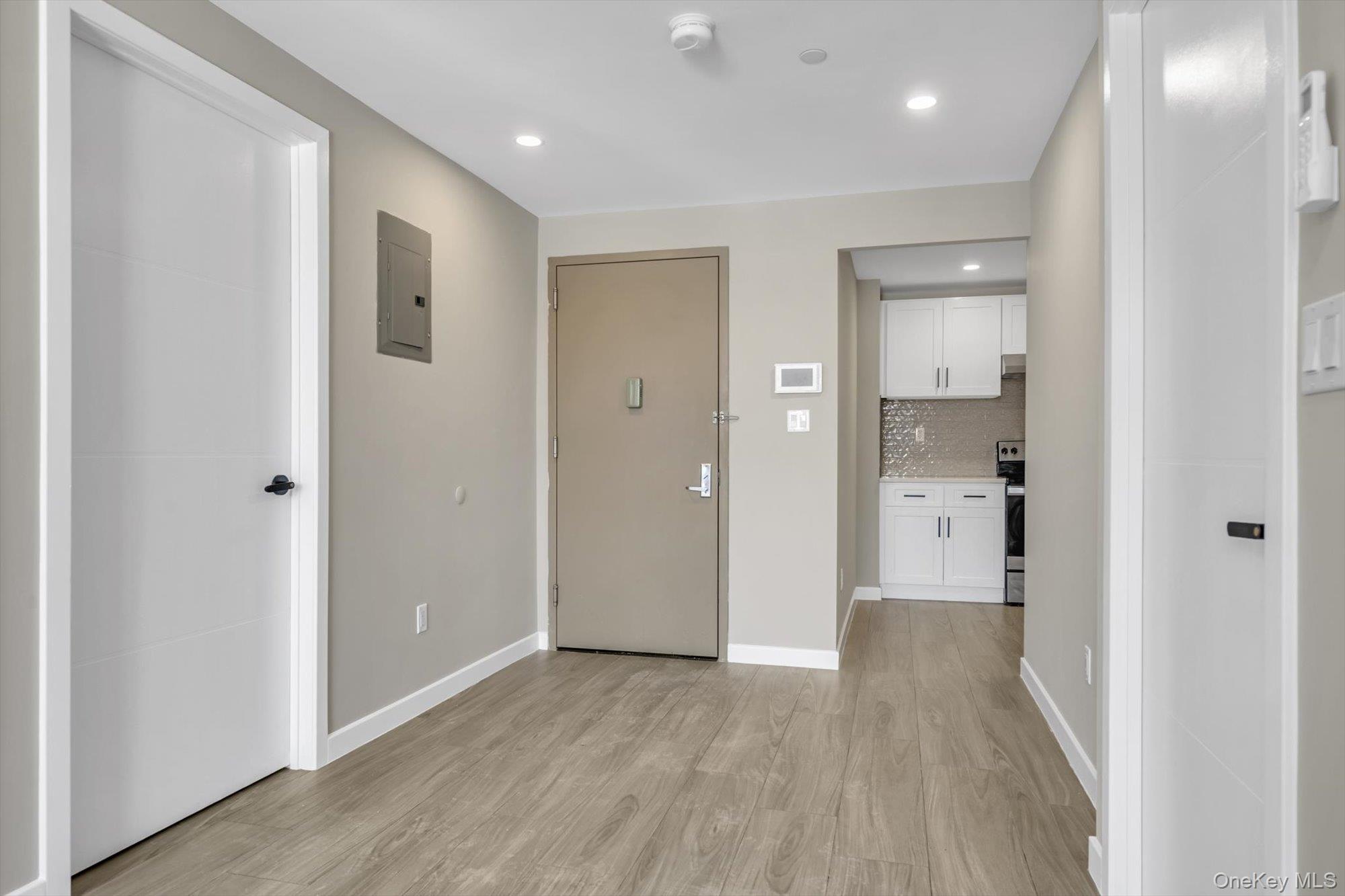 55-40 97th Place Queens, NY 11368 - Photo 4 of 11 a view of a hallway with wooden floor and a bathroom