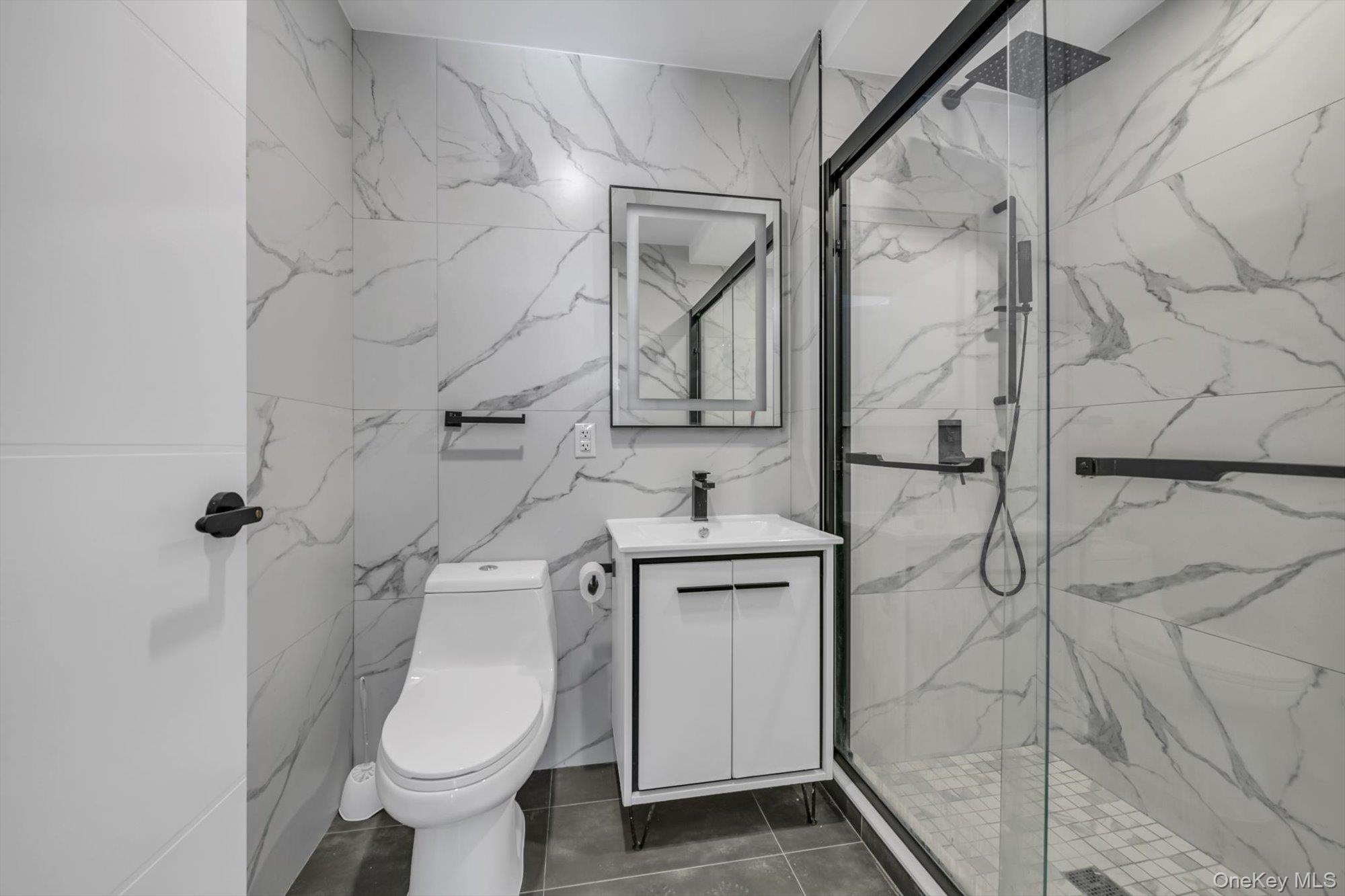 55-40 97th Place Queens, NY 11368 - Photo 8 of 11 a bathroom with a toilet and shower