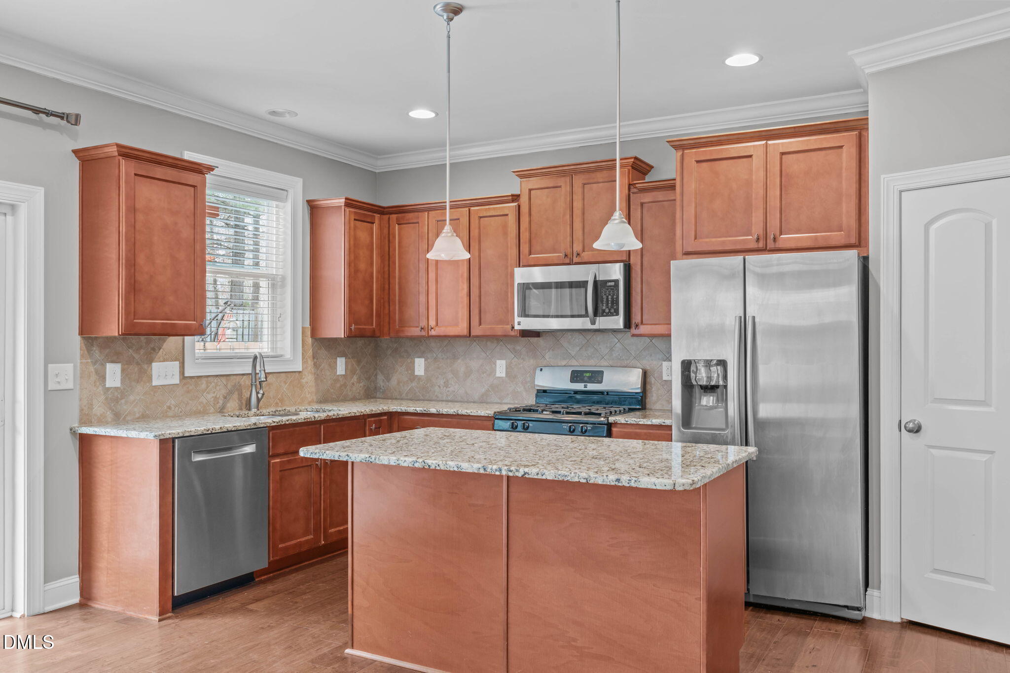 2844 Bogle Branch Court Raleigh, NC 27606 - Photo 18 of 54 a kitchen with stainless steel appliances granite countertop a refrigerator a sink a stove and white cabinets with wooden floor