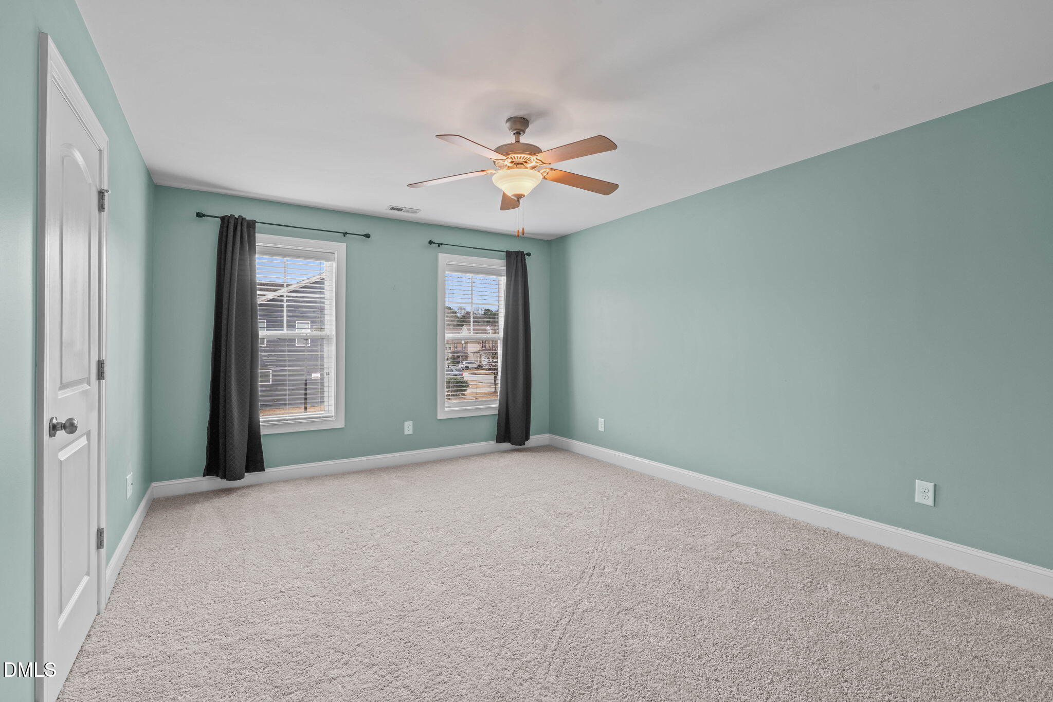 2844 Bogle Branch Court Raleigh, NC 27606 - Photo 32 of 54 an empty room with windows and fan