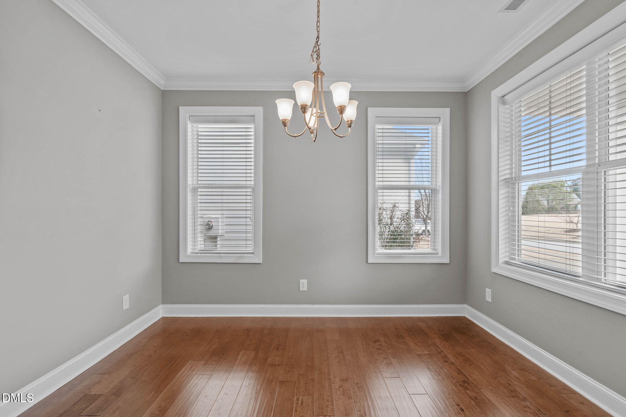 2844 Bogle Branch Court Raleigh, NC 27606 - Photo 9 of 54 a view of an empty room with wooden floor and a window