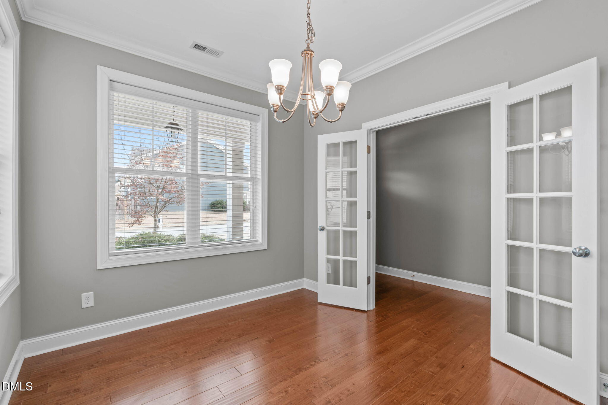 2844 Bogle Branch Court Raleigh, NC 27606 - Photo 10 of 54 a view of an empty room with a window and wooden floor