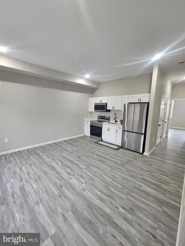 a view of kitchen with furniture and wooden floor