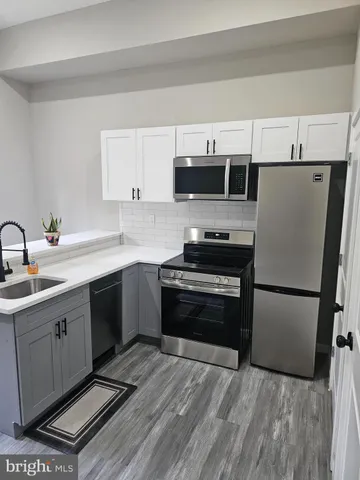 a kitchen with a sink a stove and refrigerator