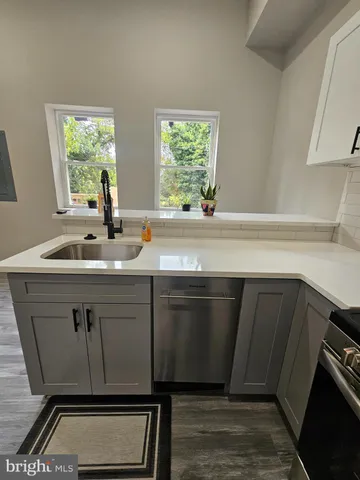a sink with granite countertop a stove a sink and a window