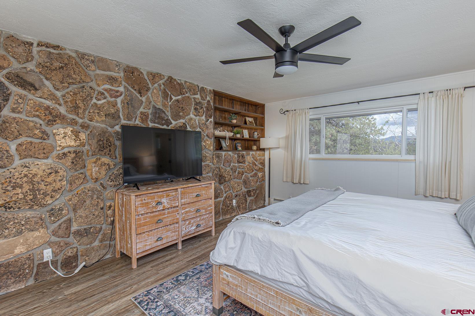 19 Newland Circle Durango, CO 81301 - Photo 20 of 44 a bedroom with a bed and a flat screen tv