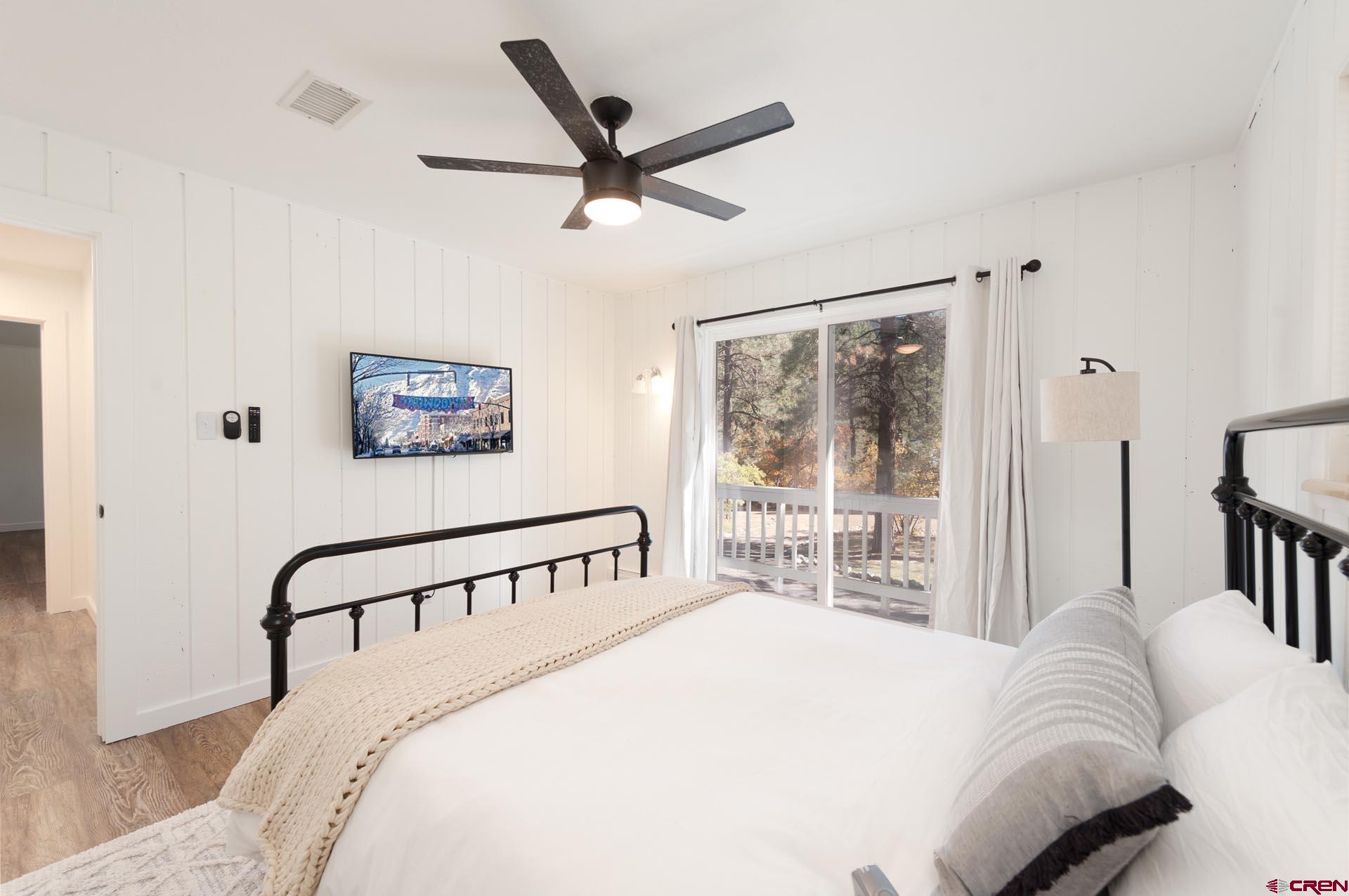 19 Newland Circle Durango, CO 81301 - Photo 28 of 44 a bedroom with a large bed and a chandelier