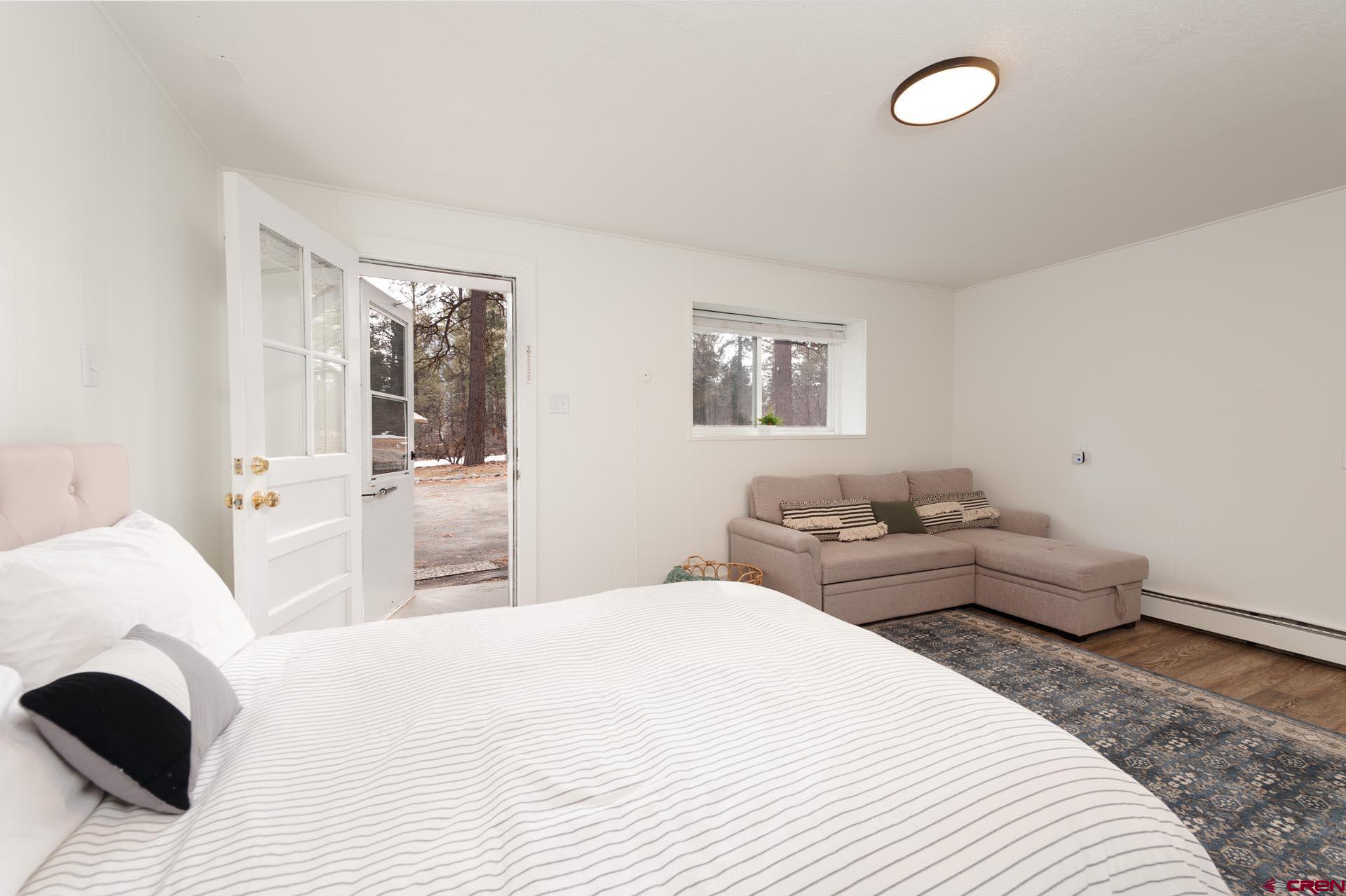 19 Newland Circle Durango, CO 81301 - Photo 33 of 44 a bedroom with a bed and wooden floor