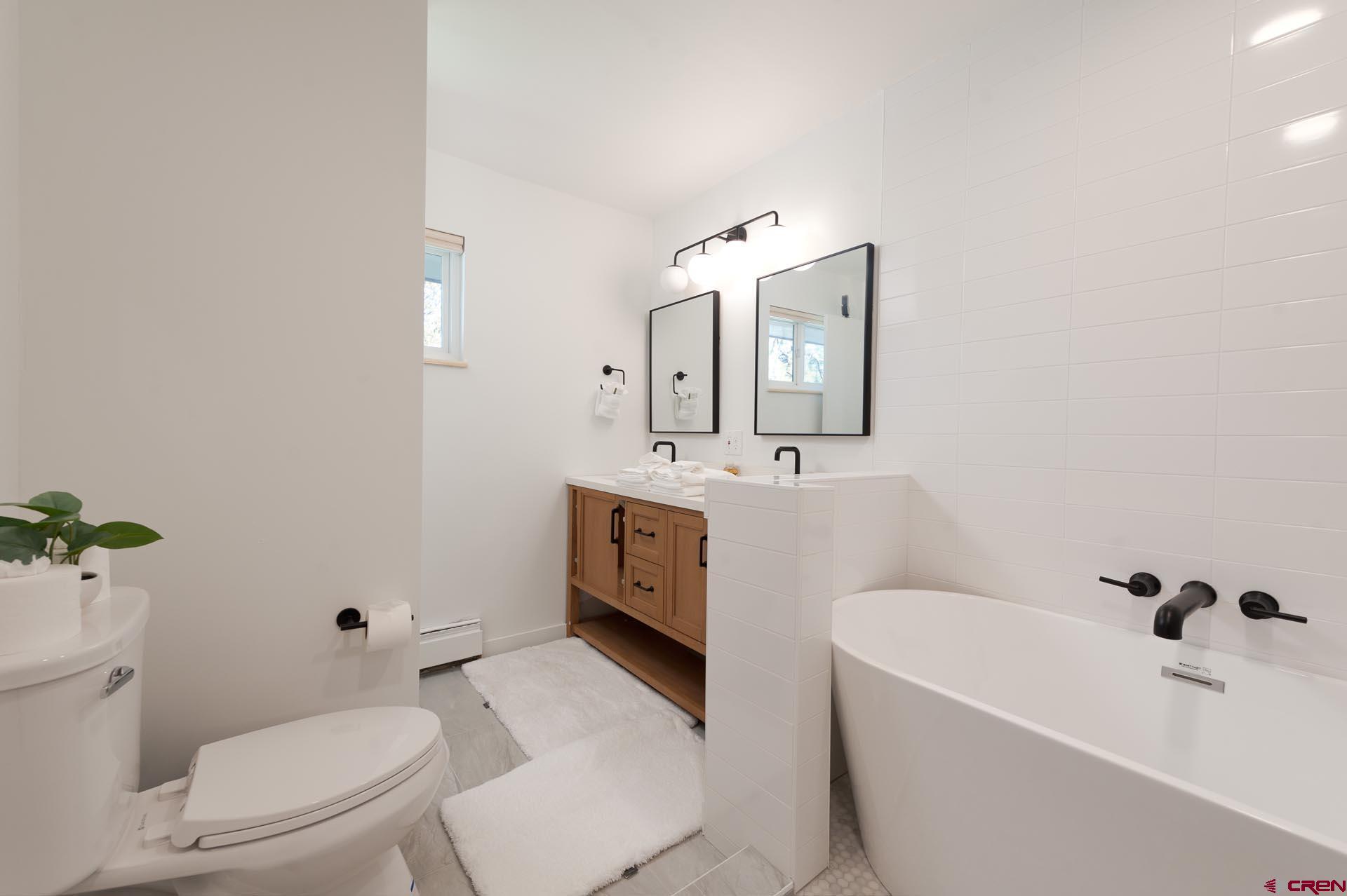 19 Newland Circle Durango, CO 81301 - Photo 34 of 44 a bathroom with a toilet a sink and mirror