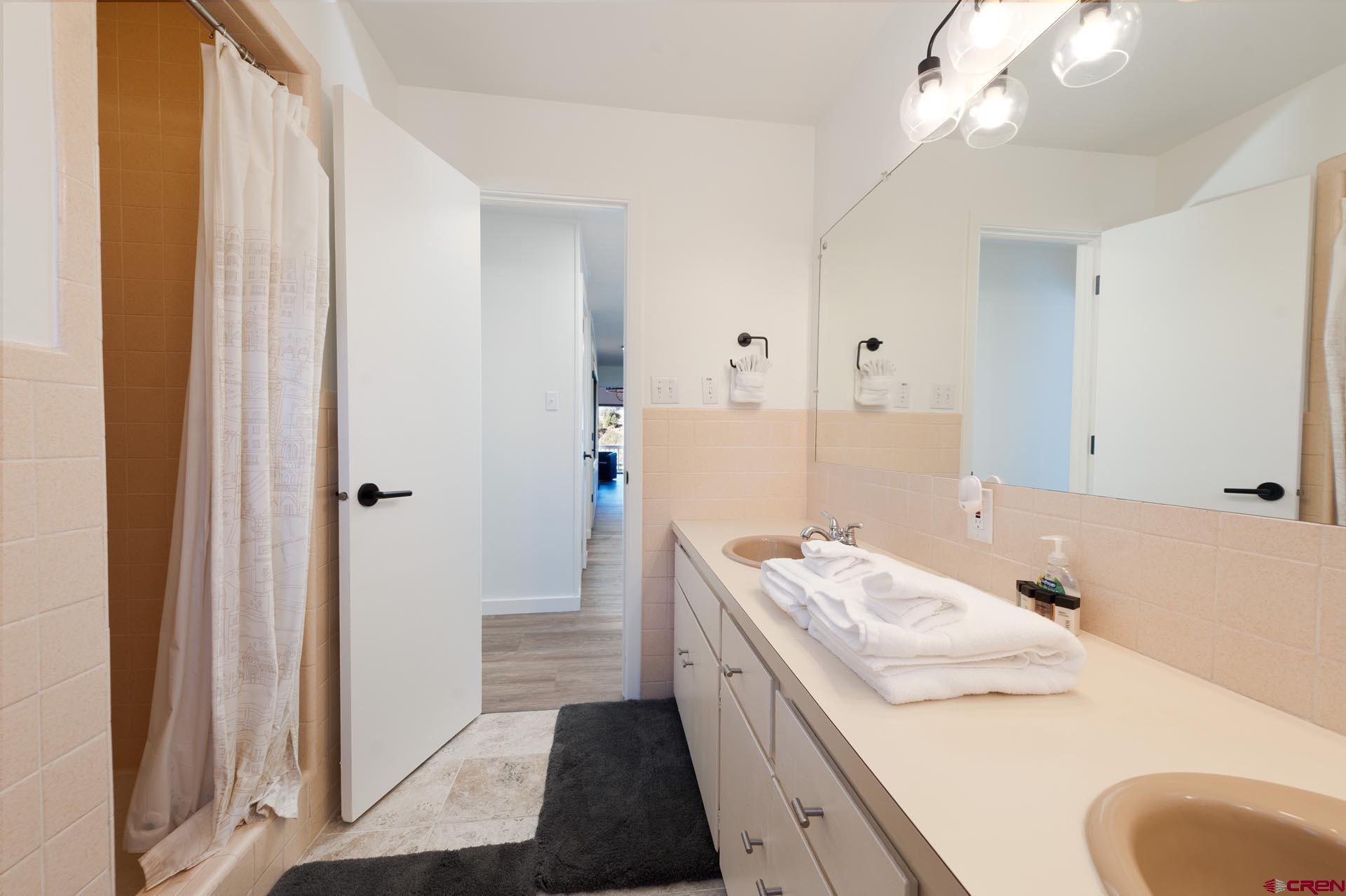 19 Newland Circle Durango, CO 81301 - Photo 36 of 44 a bathroom with a granite countertop sink and a mirror