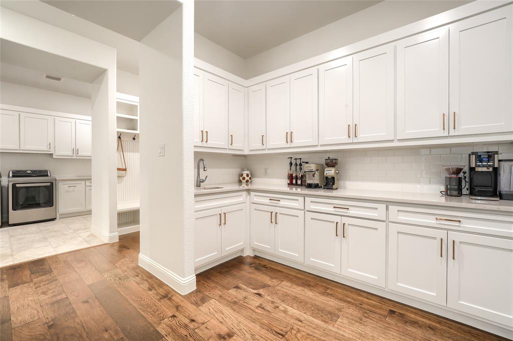 462 Infinito Drive Sunnyvale, TX 75182 - Photo 19 of 37 Kitchen with white cabinets, light wood-type flooring, stainless steel stove, and backsplash