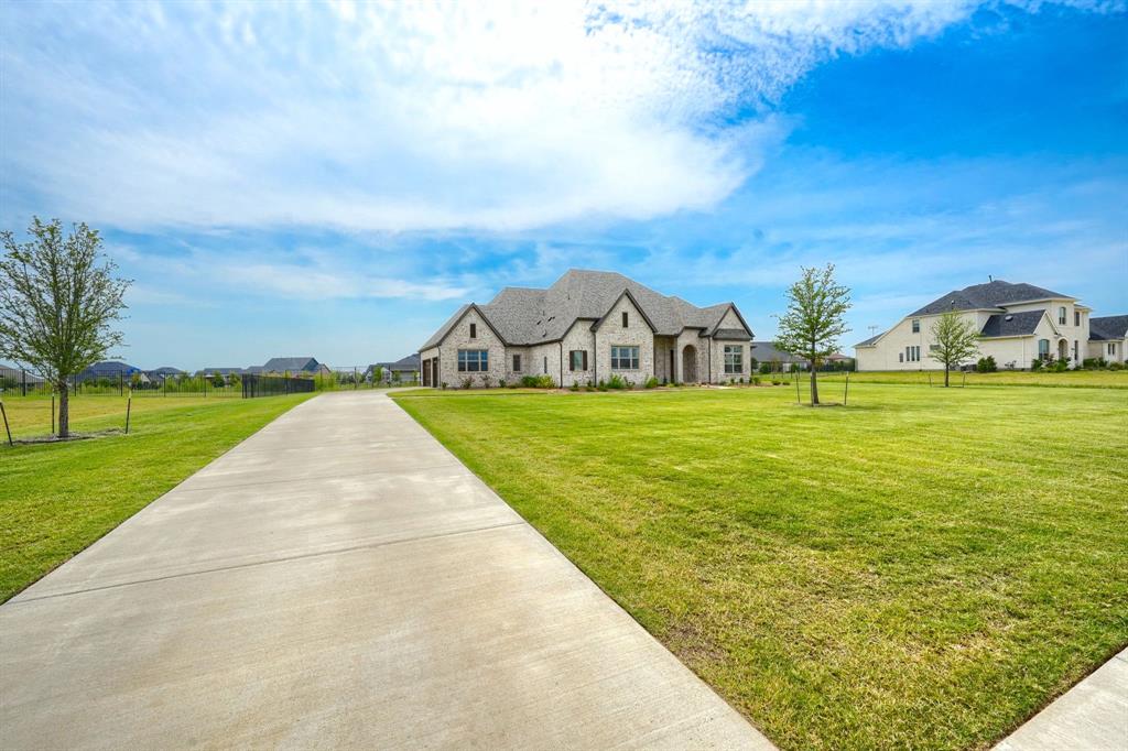 462 Infinito Drive Sunnyvale, TX 75182 - Photo 3 of 37 French country style house with stone siding, a front lawn, and a residential view