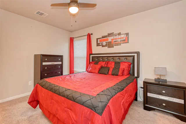 a bedroom with a bed and a dresser