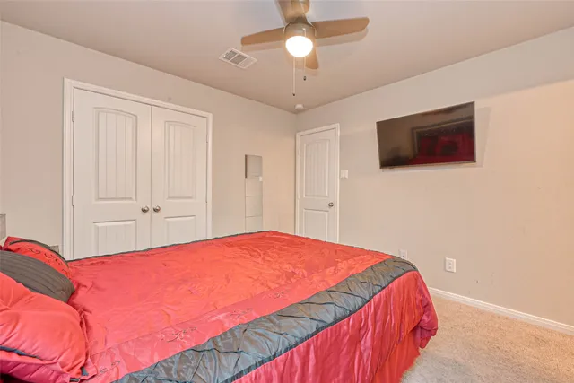 a bedroom with a bed and a flat screen tv