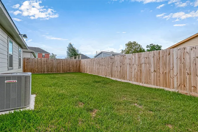a view of a backyard with wooden fence