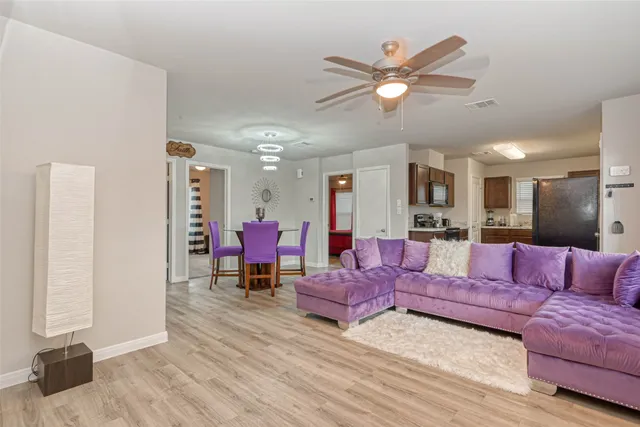 a living room with furniture and kitchen view