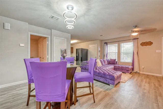 a living room with furniture a flat screen tv and a large window