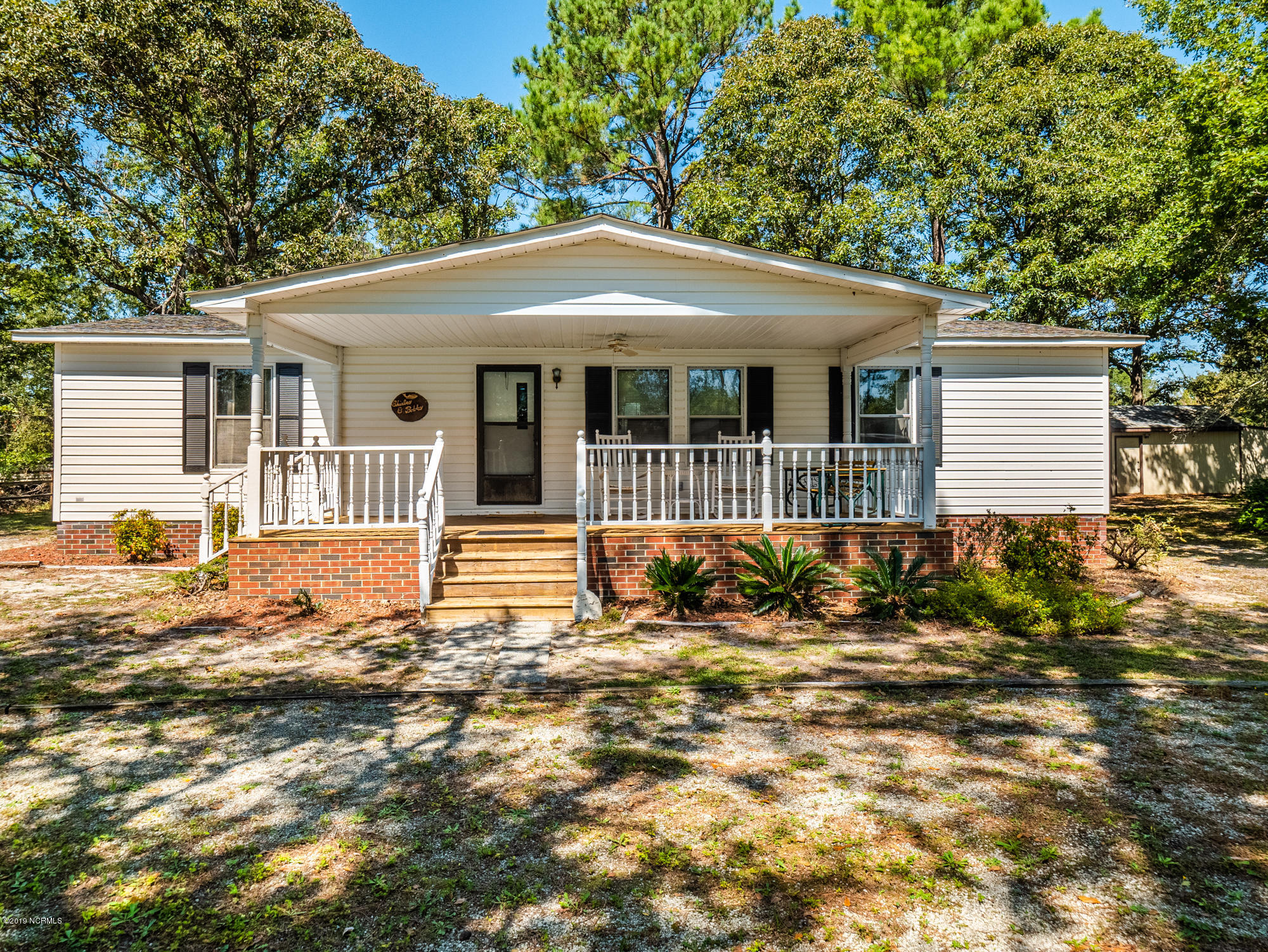 211 Doe Ridge Road Hampstead, NC 28443 - Photo 1 of 27 Front of Home with brick underpinning